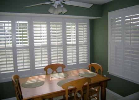 plantation window shutters - wood shutters painted white with adjustable slats